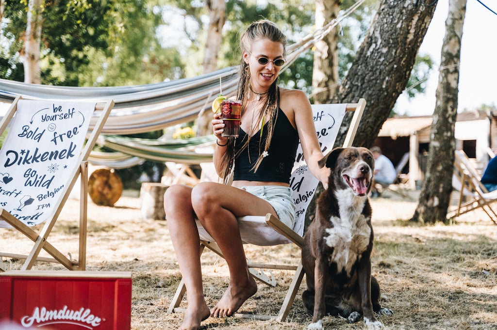 a woman sitting on a chair with a dog